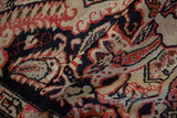 Close-up of Karabagh rug pile with red, navy, and ivory rococo leaves and botehs.