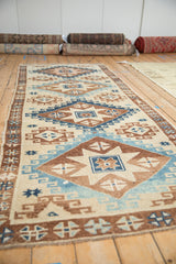 Angled view down the vintage Kars runner, highlighting its repeating diamond and starburst motifs.