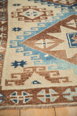 Close-up on the worn, hand-knotted pile of a vintage Kars rug with geometric motifs.
