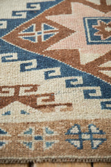 Close view of even wear to knot heads on a vintage Kars rug's geometric design.