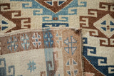 Folded corner of a vintage Kars rug displaying its hand-knotted wool pile and woven foundation.