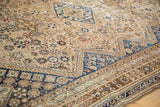 Angled view of the distressed texture and geometric patterns in sapphire blue and dusty bronze.