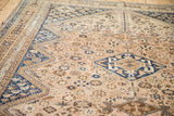 Worn, low pile texture of a vintage Persian Qashqai carpet with sapphire blue diamond medallions.