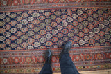 Overhead view of the antique Malayer runner's dense boteh pattern and even, short pile texture.