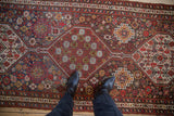 Antique Qashqai runner featuring a column of hexagonal medallions in red, blue, and yellow.