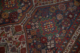 Even pile wear across the intricate geometric guls of an antique Qashqai runner.