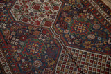 Intricate minor guls and floral elements on the evenly worn pile of a Persian rug.