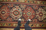 Nuanced interior fills within geometric octagonal medallions on a late 19th-century Caucasian Kazak rug.