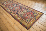 An angled, full-length view of a Caucasian Kazak runner's octagonal medallions and detailed borders.