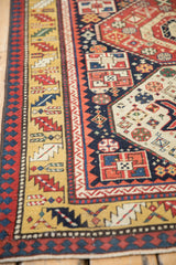 Intricate Laleh Abbasi pawn design and serrated leaf borders on an antique Caucasian Kazak runner.