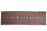 Antique Shirvan runner with geometric palmettes and multi-tiered borders in navy blue and madder red.