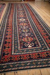 Lengthwise perspective of the antique Shirvan runner shows its central geometric column and layered borders.