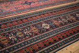 Reciprocating dragon motifs within the wide, multi-tiered border of a Caucasian Shirvan rug.