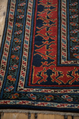 Reciprocating dragon motifs in red and navy blue beside the rug's multi-tiered floral borders.