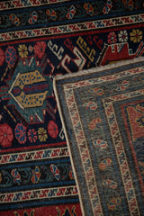 Folded corner of an antique Shirvan runner showing the front pile and reverse hand-woven foundation.