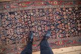 Overhead view of the vintage Bijar rug's dense Herati pattern in navy, blush, and blue.