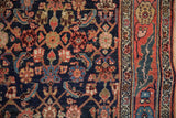 Detailed view of the vintage Bijar rug's Herati design beside its expressively drawn floral border.