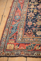 Angled detail of a vintage Bijar runner's floral borders and low pile with mostly even wear.