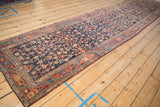 Full perspective of a vintage Bijar runner, displaying its rich navy Herati field and blush borders.