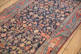 Angled view down the vintage Bijar runner, detailing the navy Herati field and dusty blush floral borders.