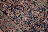 Low-pile texture of a vintage Bijar runner, showing the Herati pattern in blush and blue on navy.