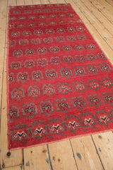 Black cherry red Oushak runner's field featuring staggered germinating floral arabesques.