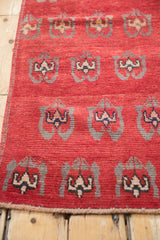 Vintage Oushak runner's hand-knotted side cord selvage in black cherry red.