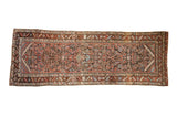 Antique Northwest Persian rug runner with a colorful allover Herati design on a dark chocolate brown field.