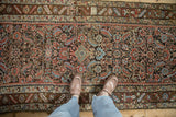 Stylized human figures and cartouche within the main border of the antique Persian Herati runner.