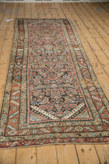 Full length angled view of the antique Persian runner highlighting its complex, allover Herati design.