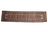 Antique Persian Malayer runner with a geometric gul field and ornate floral borders on a dark chocolate ground.