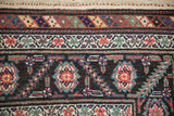Serrated leaf and floral main border alongside minor vine borders on an antique Malayer rug.