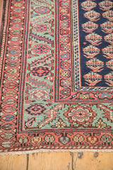 Close-up of the serrated leaf and floral motifs in this antique Malayer rug's borders.