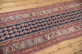 A close view of the cobalt blue boteh field and complex borders of an antique Malayer rug.