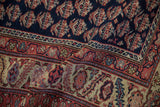 Intricate boteh motifs on a cobalt blue field next to a detailed serrated leaf border.