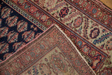 Detail of a Persian Malayer's boteh-filled navy field alongside its serrated leaf border.