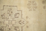 Distressed, low pile of a hand-knotted Oushak rug with geometric motifs in soft beige tones.