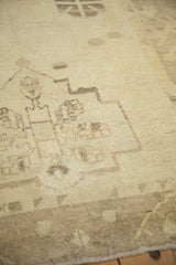 Geometric design details on the evenly worn, low pile of a vintage Oushak rug runner.