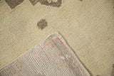 A vintage Turkish rug's corner folded over to reveal the hand-knotted construction and low pile.