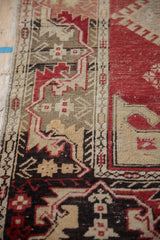 Close-up of the distressed Oushak's border with vine and hook-and-latch motifs.