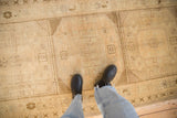 Distressed Oushak runner featuring cream, bronze, and olive geometric motifs.