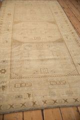 Distressed Oushak runner detail with low pile, cream, antique ivory gul medallions.