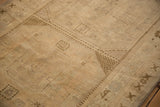 Distressed vintage Oushak runner's textured pile showing subtle checkered and cross-hatch motifs.