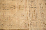 Fragmented checkered geometric overlay and distressed low pile on vintage Oushak rug.