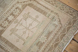Distressed vintage Oushak runner with geometric guls and faded rose abrashes on beige pile.