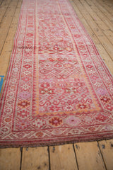 Distressed vintage Kurd runner with heavy abrashes, geometric guls in dusty fuchsia, pale tangerine.