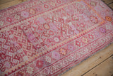 Distressed vintage Kurd runner detail, showing geometric motifs, dusty fuchsia, and pale tangerine abrash.