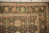 Corner of Vintage Sivas runner: floral motifs in jade green, pale coffee, and ivory fringe.