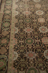 Sivas runner detail: worn pile, coffee brown field, jade green floral medallions.