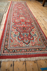 View from the end of a vintage Arak runner, looking down its brick red floral length.